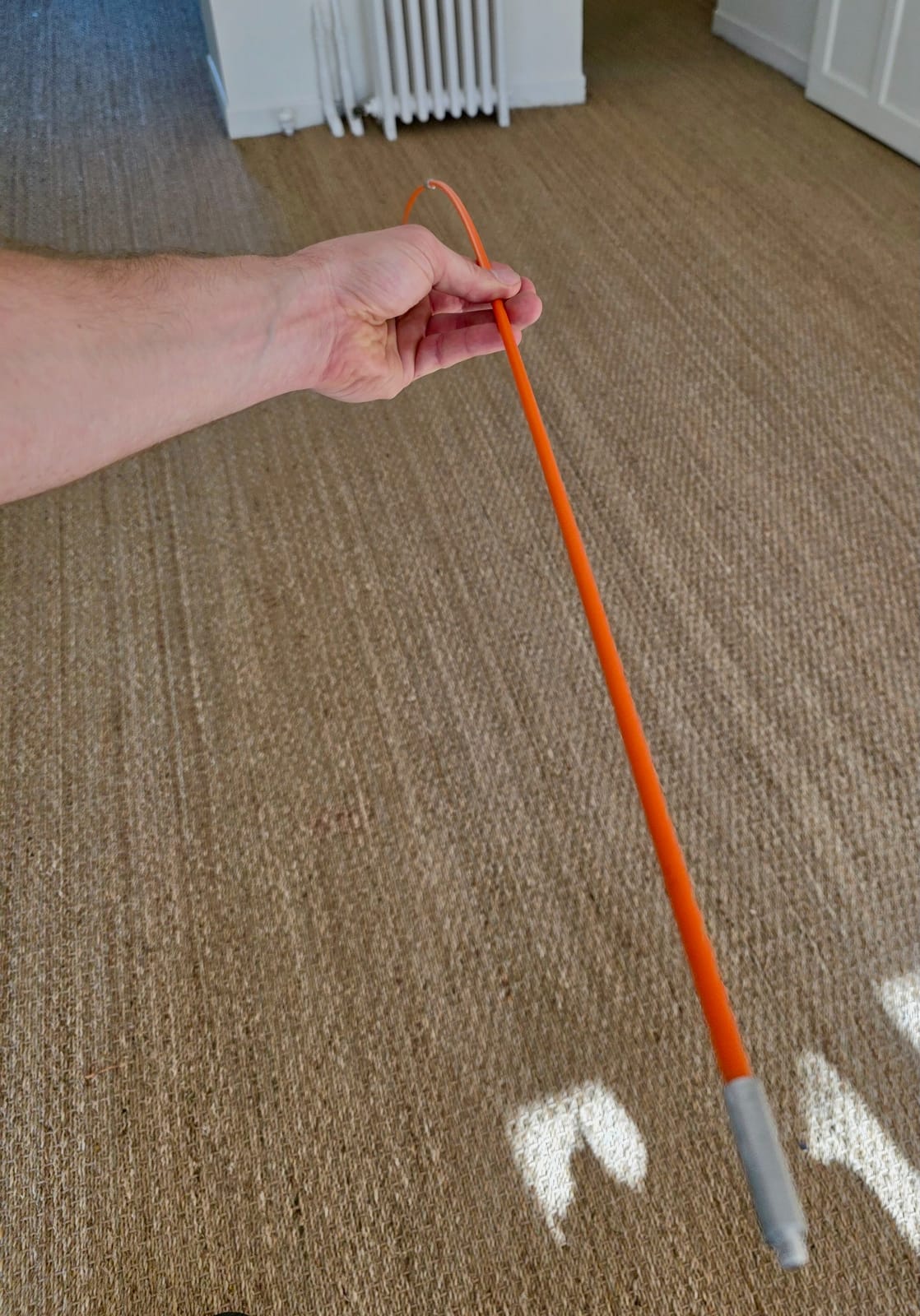 Orange Taravello Pro screw-together rod held in hand, with a metal coupling visible