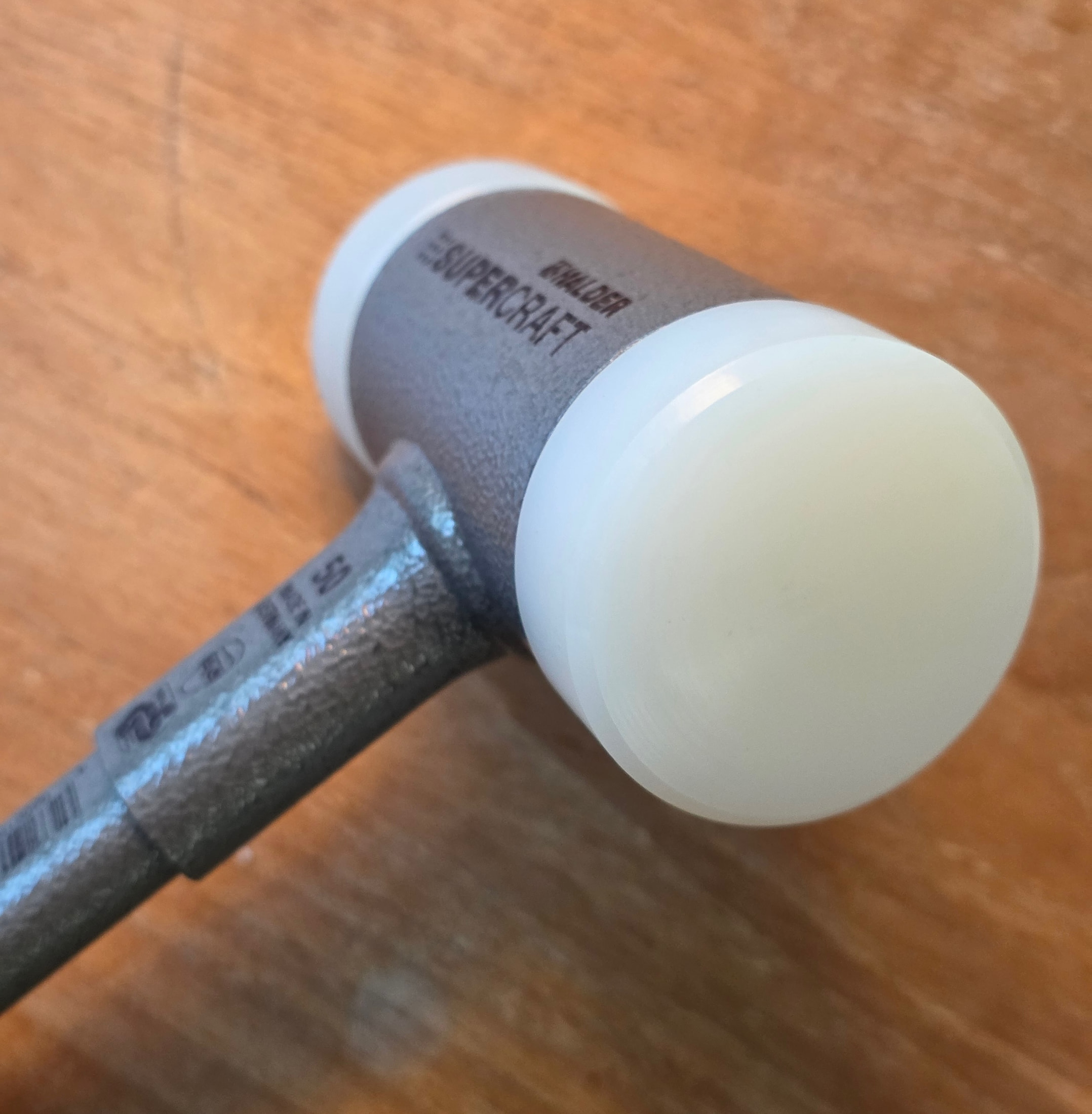 Head and replaceable white nylon insert of the HALDER SUPERCRAFT 3377.050 on a wooden surface