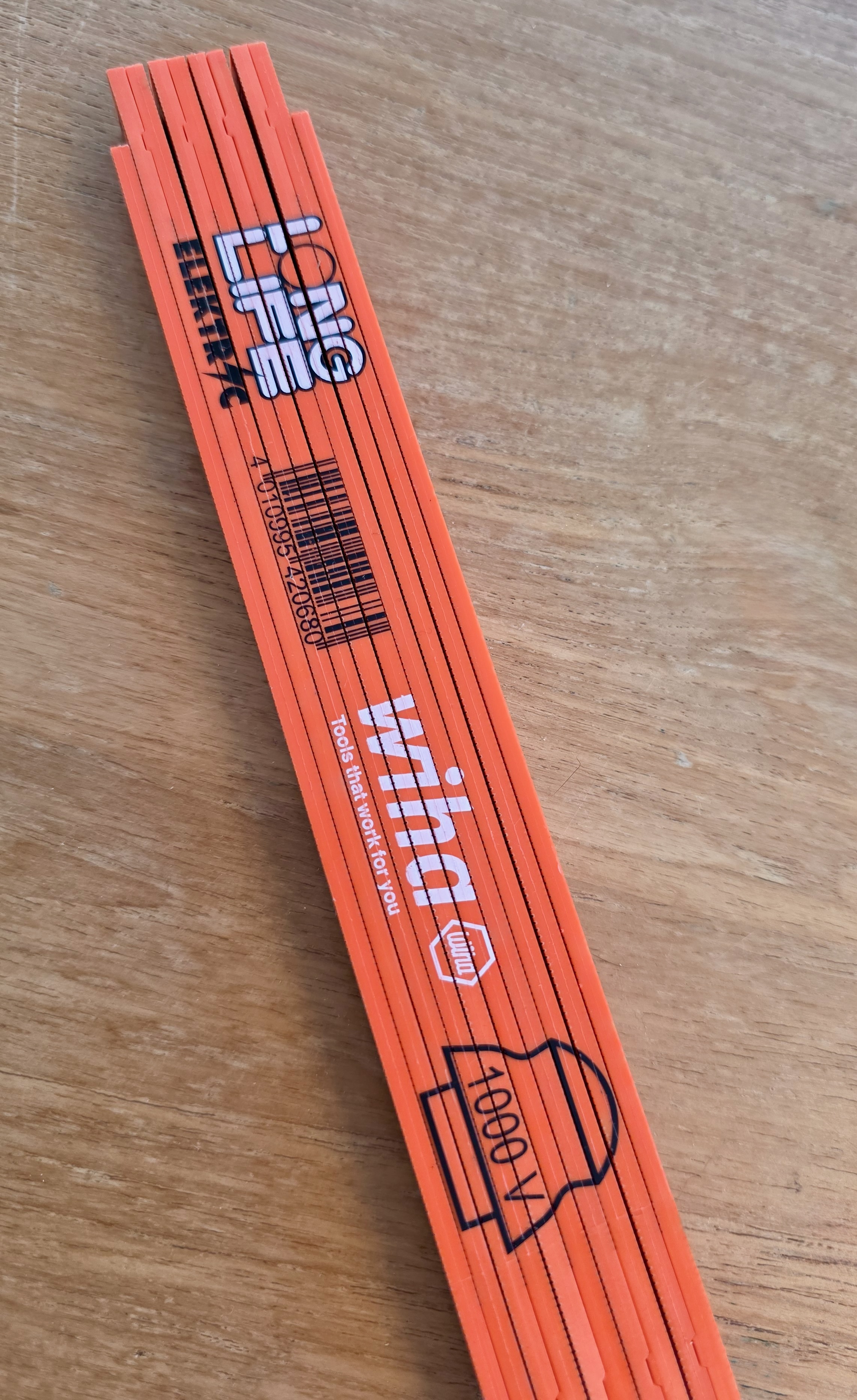 Wiha VDE 1000 V rigid ruler placed on a table, printed VDE marking visible